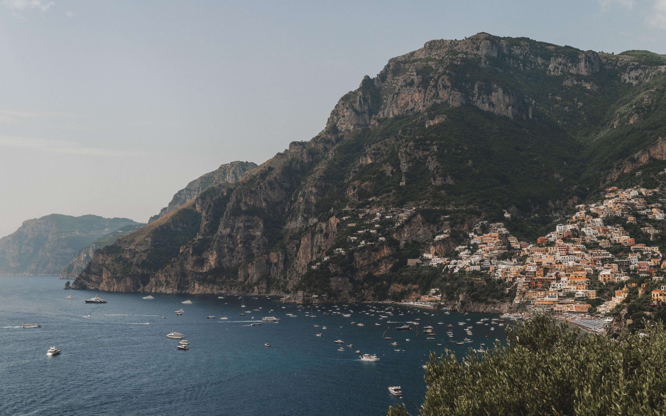 A scenic view of Positano's colorful cliffside buildings overlooking the Mediterranean Sea 